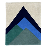 Rug with geometric mountain design in navy, blue, and green on a beige background
